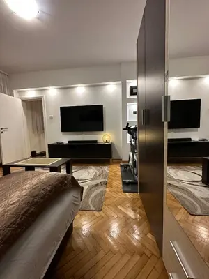 a living room with a couch and a television at Cherrycity apartments in Belgrade