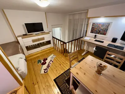 a small living room with a table and a television at Cherrycity apartments in Belgrade