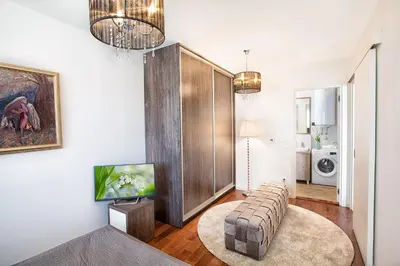 a living room with a couch and a tv at A Blok-Apartment The One in Belgrade