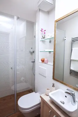 a bathroom with a toilet and a sink and a mirror at A Blok-Apartment The One in Belgrade