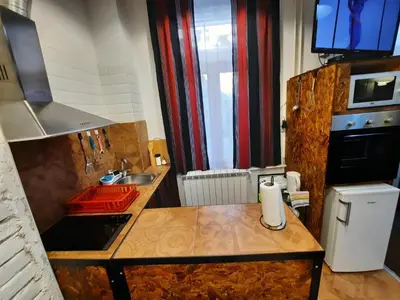 a kitchen with a sink and a counter top at Authentic Belgrade Centre - Split Level loft with Patio in Courtyard in Belgrade