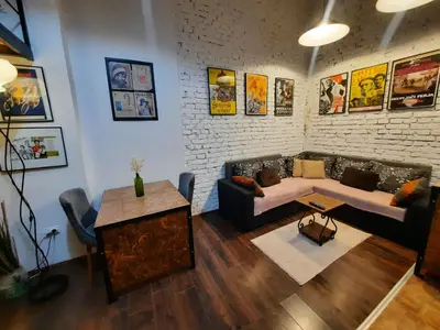 a living room with a couch and a table at Authentic Belgrade Centre - Split Level loft with Patio in Courtyard in Belgrade