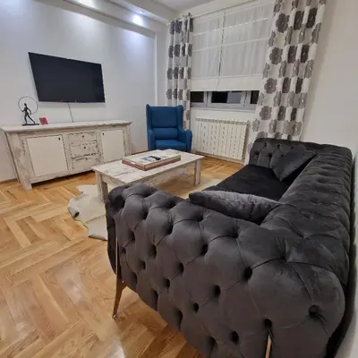a living room with a couch and a tv at M48 apartments in Belgrade