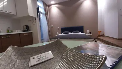 a room with a bed and a table with a sign on it at M48 apartments in Belgrade