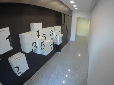 a hallway with white clocks on the wall at M48 apartments in Belgrade