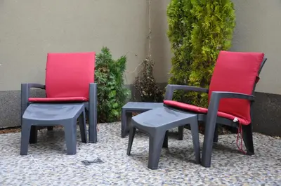 a couple of chairs and a table with red cushions at M48 apartments in Belgrade