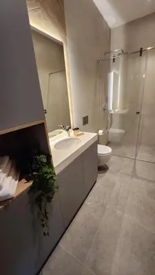 a bathroom with a sink and a shower and a toilet at City Nest Modern & Cozy Suites in Belgrade