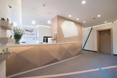 an office lobby with a reception counter and a door at City Nest Modern & Cozy Suites in Belgrade