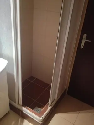a shower with a glass door in a bathroom at Markoni in Pančevo