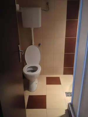 a bathroom with a white toilet in a room at Markoni in Pančevo