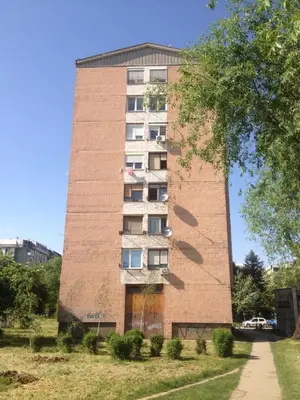 a tall brick building with windows on the side at Markoni in Pančevo