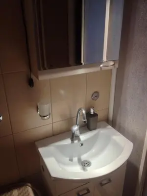 a white sink in a small bathroom at Markoni in Pančevo