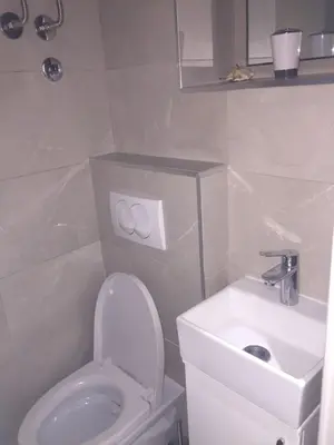 a bathroom with a white toilet and a sink at Talisman in Belgrade