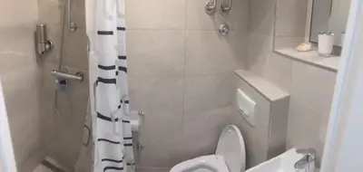 a small bathroom with a toilet and a shower at Talisman in Belgrade