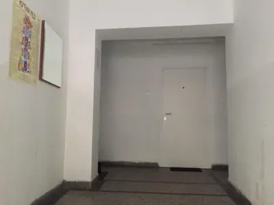 an empty hallway with a white wall and a door at Talisman in Belgrade