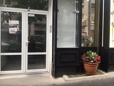 a door of a store with a potted plant in front at Talisman in Belgrade
