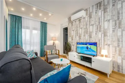 a living room with a couch and a tv at Apartman Tirena in Belgrade