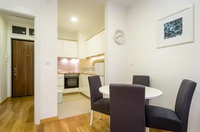 a kitchen and dining room with a table and chairs at Apartman Tirena in Belgrade