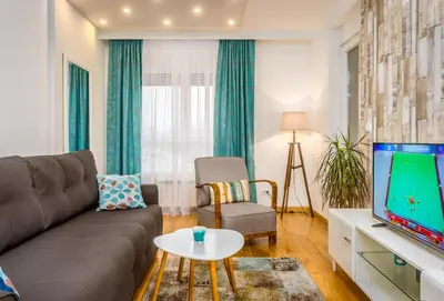 a living room with a couch and a tv at Apartman Tirena in Belgrade