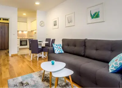 a living room with a couch and a table at Apartman Tirena in Belgrade
