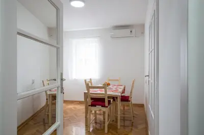 a dining room with a table and chairs and a window at Apartment Slavija square/Clinical center of Serbia in Belgrade