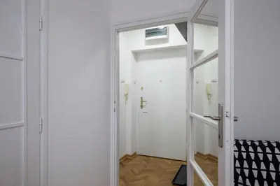 a hallway with a white door and a mirror at Apartment Slavija square/Clinical center of Serbia in Belgrade