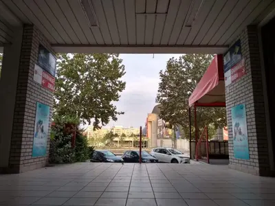 a building with cars parked in a parking lot at Arena Relax Apartman in Belgrade