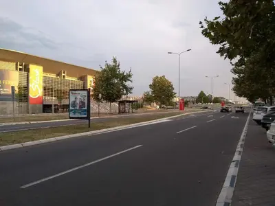 an empty street in front of a building at Arena Relax Apartman in Belgrade