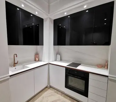 a kitchen with two sinks and two windows at Max Central Apartment in Belgrade