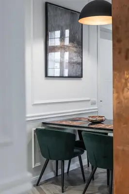 a dining room with a table and green chairs at Max Central Apartment in Belgrade