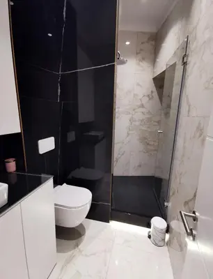 a bathroom with a toilet and a glass shower at Max Central Apartment in Belgrade
