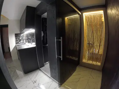 a bathroom with two doors and a sink and a mirror at Vila Argola - Spa Luxury Apartments in Belgrade