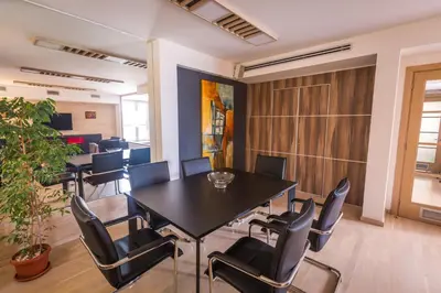 an office meeting room with a table and chairs at HostGost Selected Suites - BAMS, Private Spa included in Belgrade