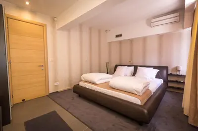 a bedroom with a bed with white pillows on it at HostGost Selected Suites - BAMS, Private Spa included in Belgrade