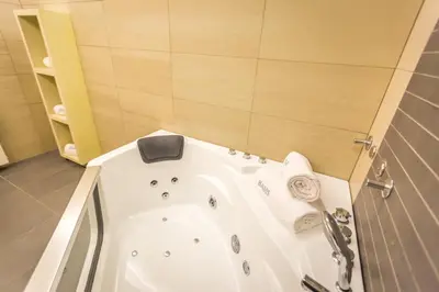 a bathroom with a white tub in a room at HostGost Selected Suites - BAMS, Private Spa included in Belgrade