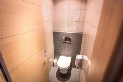 a small bathroom with a toilet in a stall at HostGost Selected Suites - BAMS, Private Spa included in Belgrade