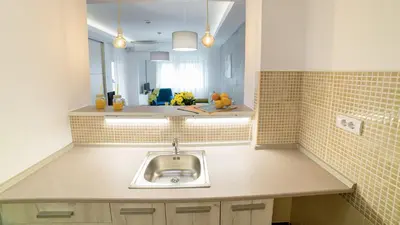 a kitchen with a sink and a mirror at Novel Inn in Belgrade