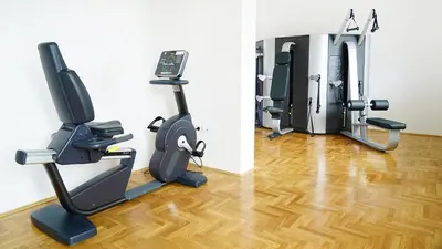 a room with two treadmills and a gym at Novel Inn in Belgrade