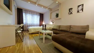 a living room with a couch and a table at Apartment OASIS in Belgrade