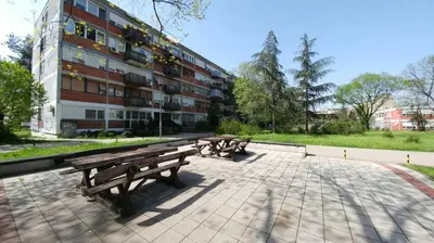 a row of benches sitting in front of a building at Apartment OASIS in Belgrade
