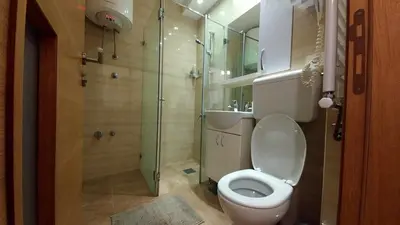 a bathroom with a toilet and a glass shower at Apartment OASIS in Belgrade