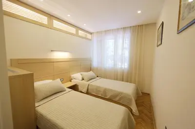 a room with two beds and a window at Apartment Piano in Belgrade