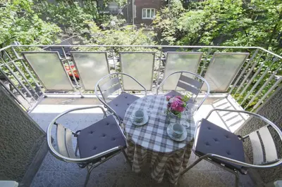 a table and chairs sitting on a balcony at Apartment Piano in Belgrade