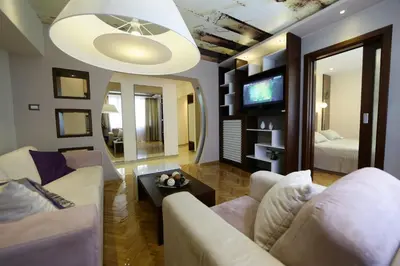 a living room with two couches and a tv at Apartment Piano in Belgrade