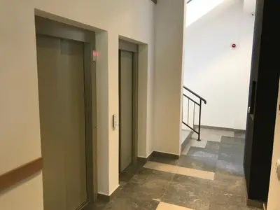 a hallway with two doors and a stairway at Zaza apartman in Belgrade