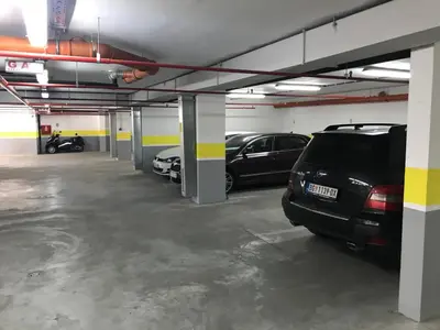 a parking garage with cars parked in it at Zaza apartman in Belgrade