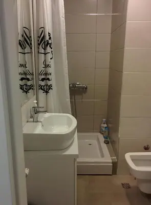 a bathroom with a sink and a toilet and a tub at Zaza apartman in Belgrade