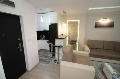 a living room with a couch and a table in a room at Diva Lux Apartman in Belgrade
