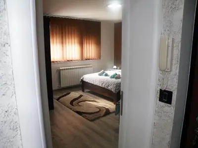 a bedroom with a bed and a window at Kristal Apartmani in Arandjelovac