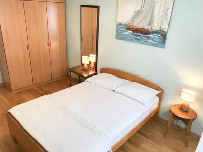 a bedroom with a bed and a painting on the wall at Central and modern in Belgrade